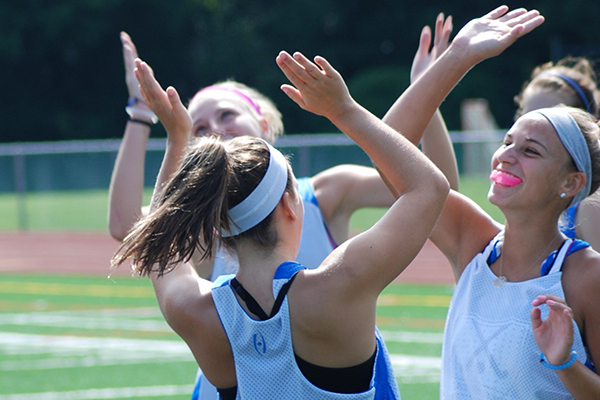 Field Hockey Camps - Campers High Fiving Revolution Rise